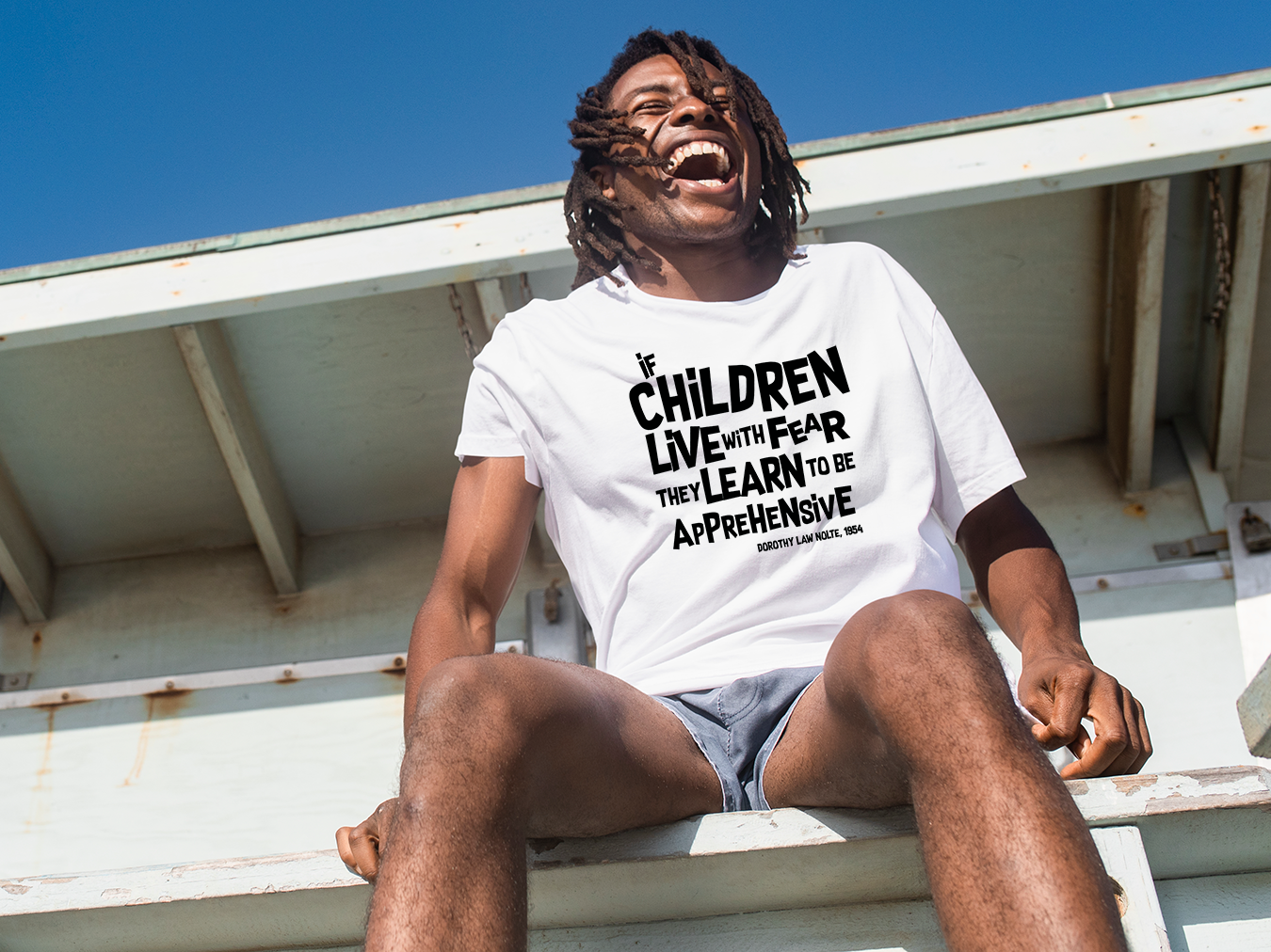 “If children live with fear, they learn to be apprehensive” – White  (Bella+Canvas) T-shirt